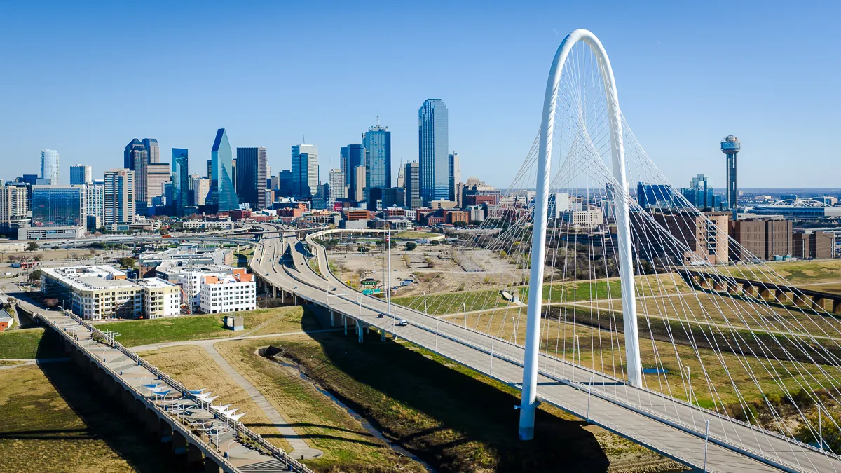 Drone aerial photo taken of Dallas Skyline on a sunny day with blue skies.